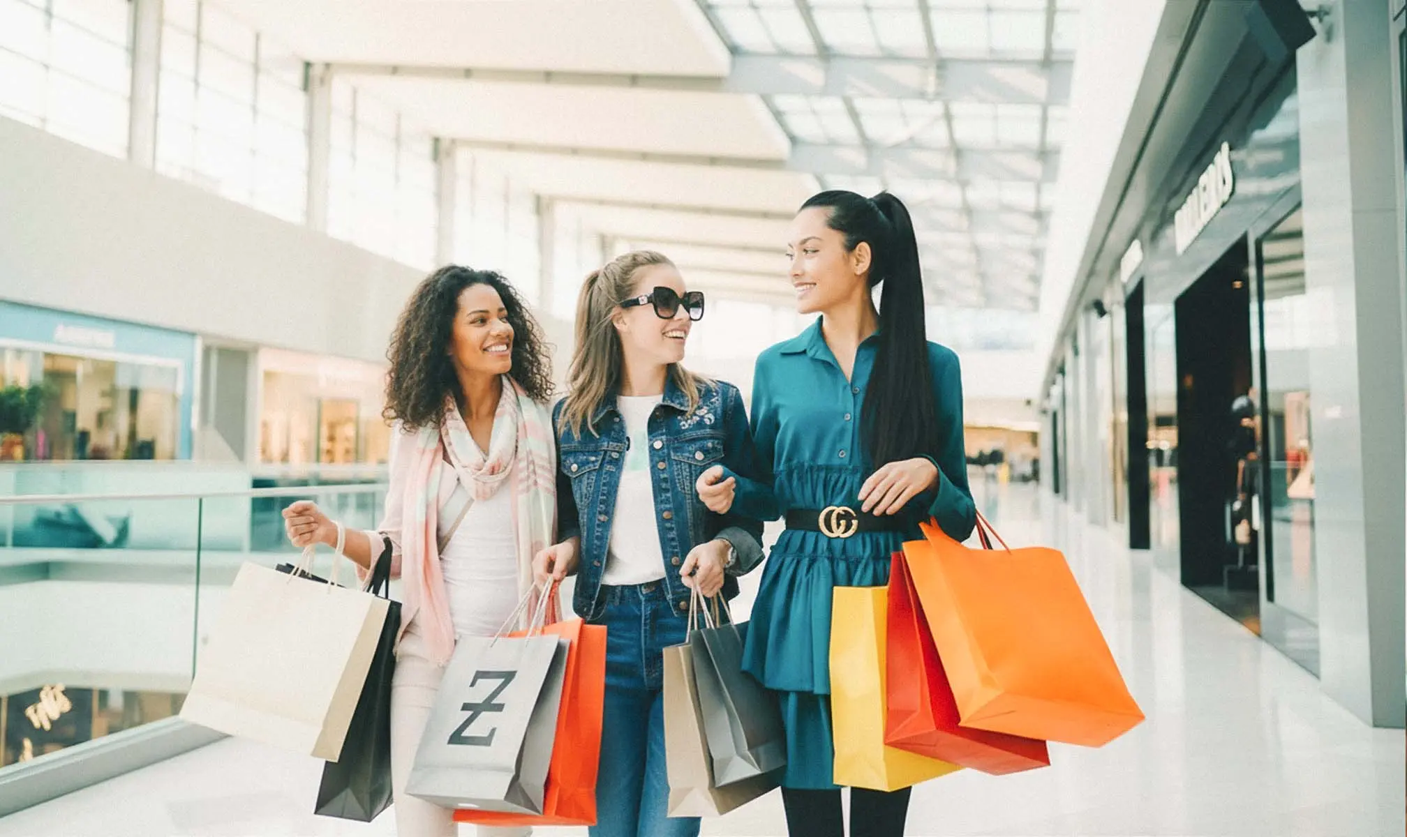 Shoppers carrying bags inside a mall